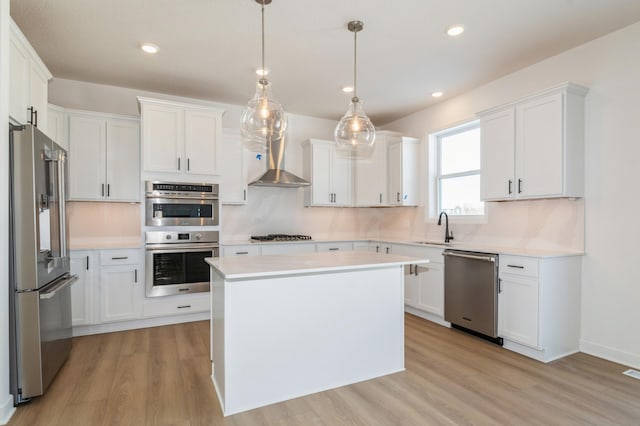 kitchen with sink, white cabinetry, decorative light fixtures, a center island, and stainless steel appliances