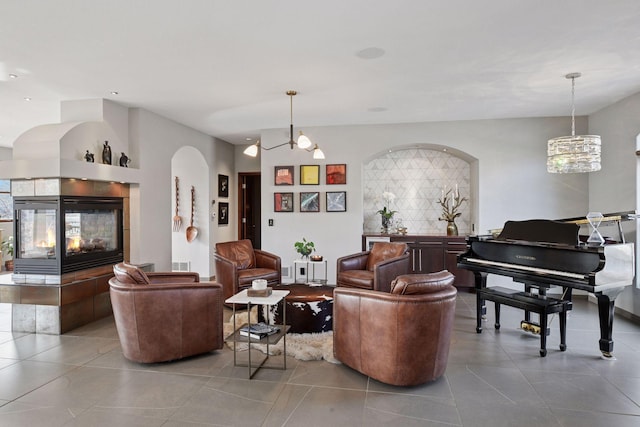 tiled living area featuring a multi sided fireplace