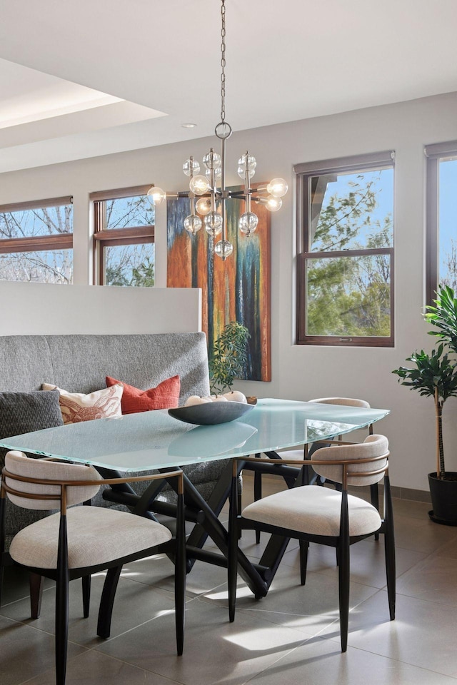 dining room featuring a chandelier, breakfast area, and a healthy amount of sunlight