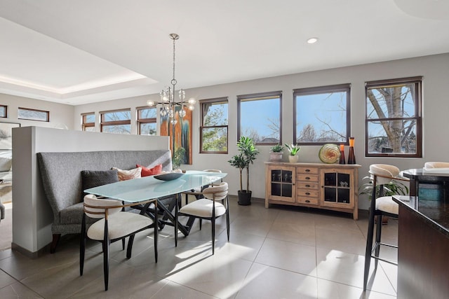 dining room featuring recessed lighting, light tile patterned flooring, a raised ceiling, and an inviting chandelier