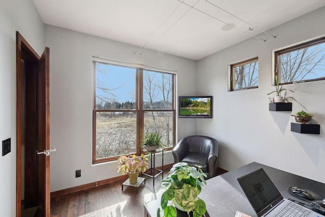 interior space featuring wood finished floors and baseboards