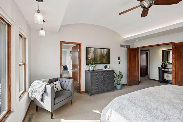 bedroom with lofted ceiling, visible vents, baseboards, and light colored carpet