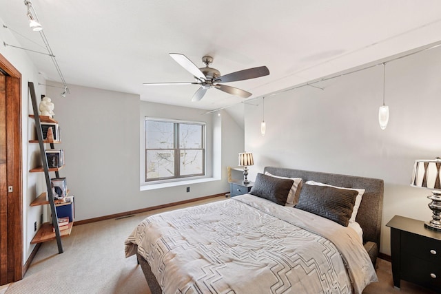 bedroom with carpet, baseboards, and a ceiling fan