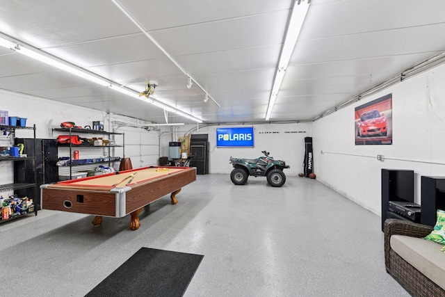 rec room with a garage, billiards, water heater, and speckled floor