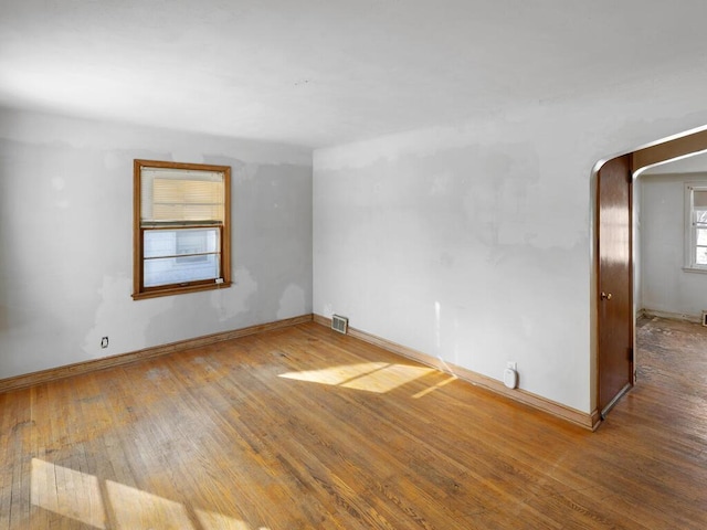 spare room featuring wood-type flooring