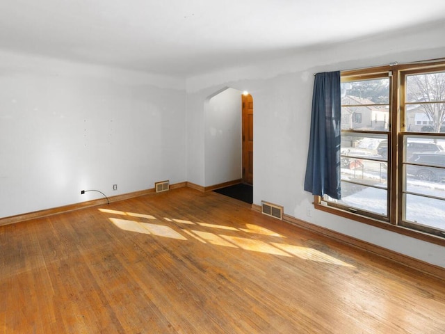 spare room with hardwood / wood-style floors