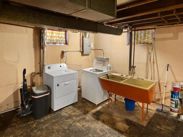 washroom with sink, electric panel, and washer and dryer