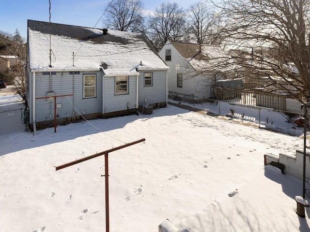 snow covered back of property with cooling unit