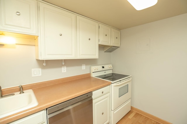 kitchen with sink, stainless steel dishwasher, white cabinets, and electric stove