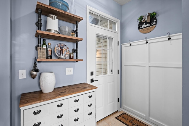 doorway with light tile patterned floors