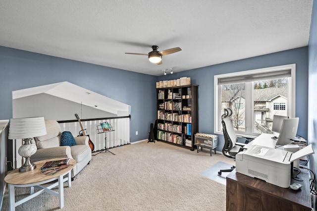 office area featuring a textured ceiling, ceiling fan, carpet, and baseboards