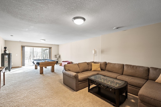 rec room featuring pool table, light colored carpet, and a textured ceiling