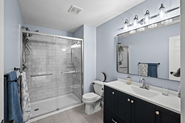 full bath with visible vents, tile patterned flooring, toilet, a textured ceiling, and a shower stall