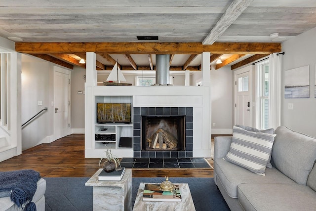 living room featuring beam ceiling, a fireplace, and dark hardwood / wood-style floors