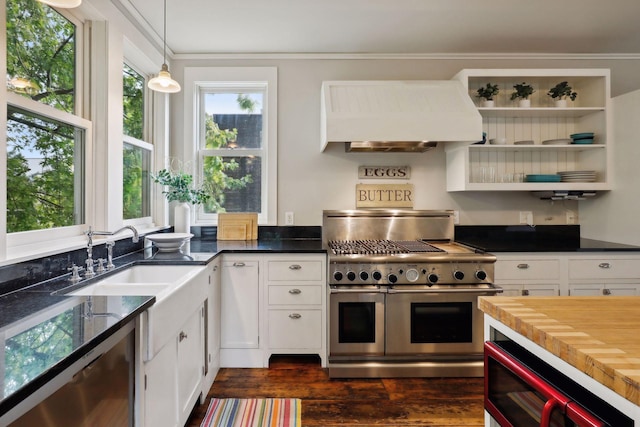 kitchen featuring dark wood-type flooring, wooden counters, appliances with stainless steel finishes, custom range hood, and white cabinets