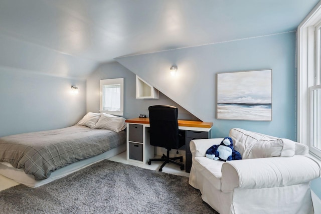 bedroom with carpet and lofted ceiling