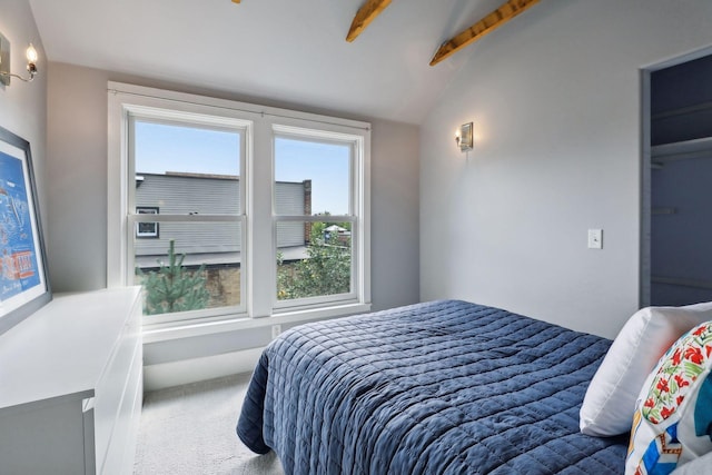 carpeted bedroom with vaulted ceiling with beams