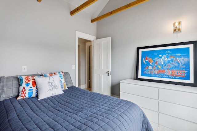 bedroom with beamed ceiling and high vaulted ceiling