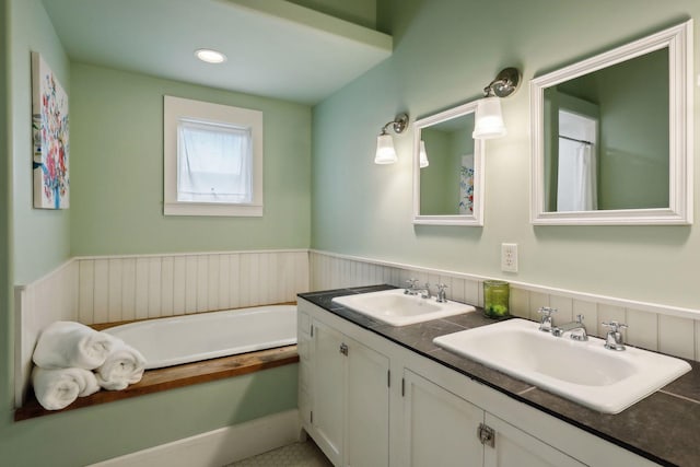 bathroom with vanity and a bathtub