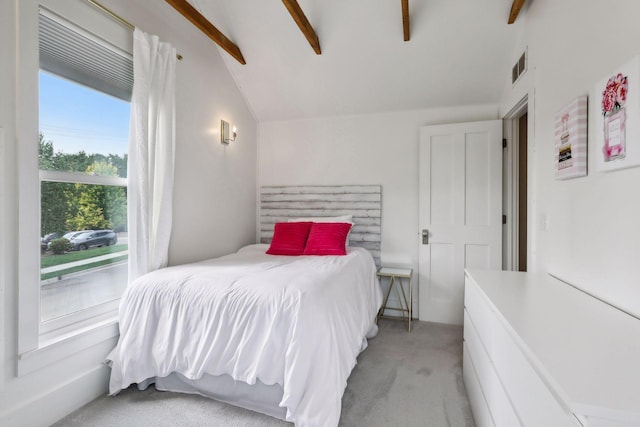 carpeted bedroom featuring vaulted ceiling with beams