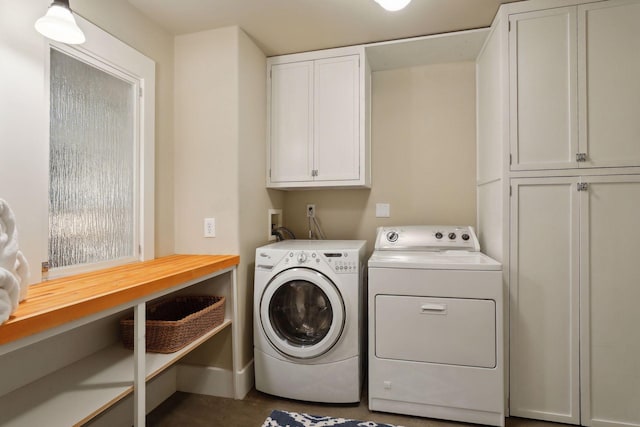 washroom with cabinets and separate washer and dryer