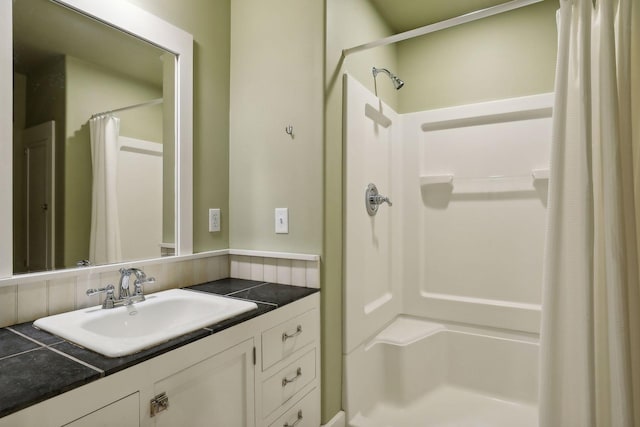 bathroom featuring vanity and a shower with shower curtain