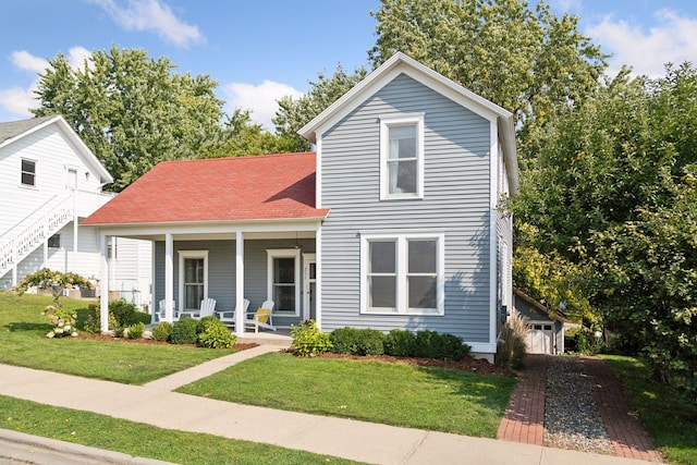 front of property featuring covered porch and a front lawn