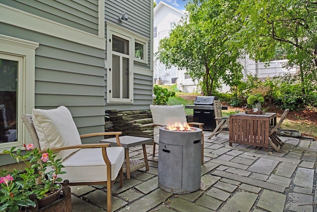 view of patio / terrace featuring grilling area and a fire pit