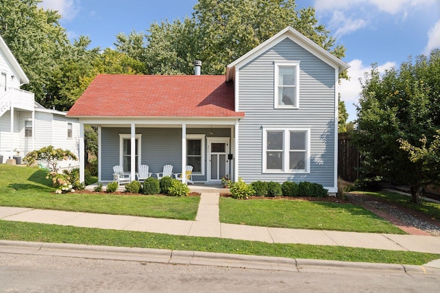 view of front of home featuring a front yard and covered porch