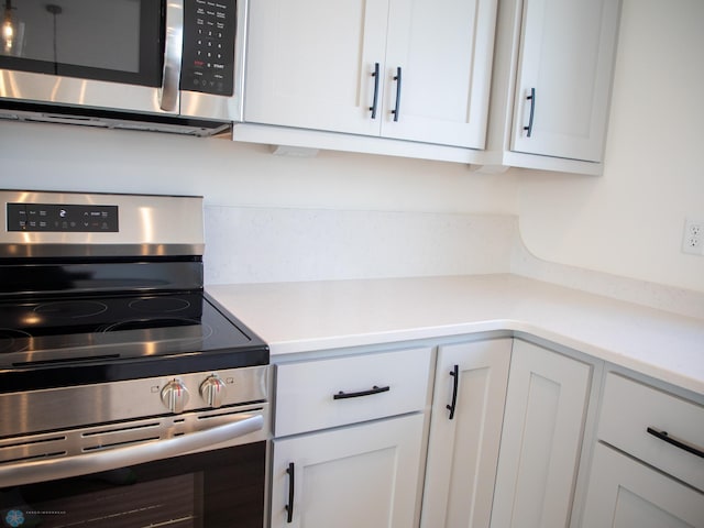 kitchen with white cabinetry and appliances with stainless steel finishes