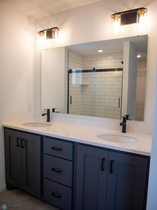 bathroom with vanity and a shower with door