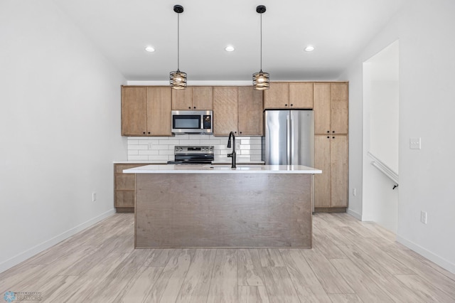 69 Cedar Dr, Mapleton, ND 58059 - kitchen featuring appliances with stainless steel finishes, a center island with sink, decorative backsplash, light countertops, and recessed lighting