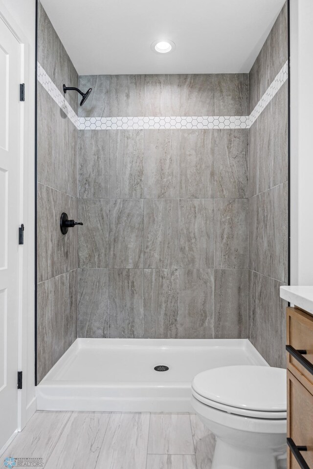 69 Cedar Dr, Mapleton, ND 58059 - full bath with vanity, toilet, a stall shower, recessed lighting, and marble look tile flooring