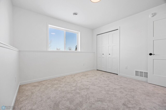 69 Cedar Dr, Mapleton, ND 58059 - unfurnished bedroom with baseboards, carpet floors, and a closet