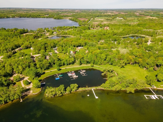 aerial view featuring a water view and a forest view