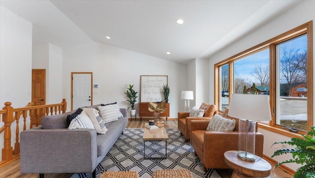 living area featuring vaulted ceiling, light wood-type flooring, plenty of natural light, and recessed lighting