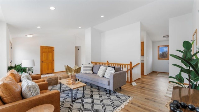 living area with vaulted ceiling, recessed lighting, and light wood-style floors