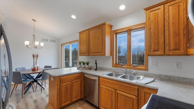 kitchen with lofted ceiling, a peninsula, a sink, stainless steel dishwasher, and brown cabinetry