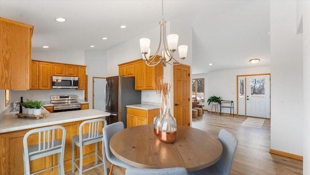 kitchen featuring light wood-style flooring, stainless steel appliances, light countertops, and recessed lighting