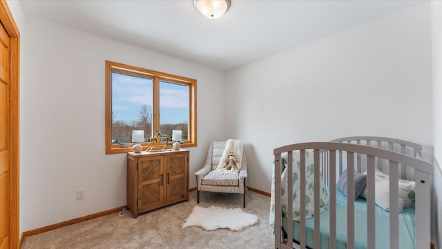 bedroom with light carpet and baseboards