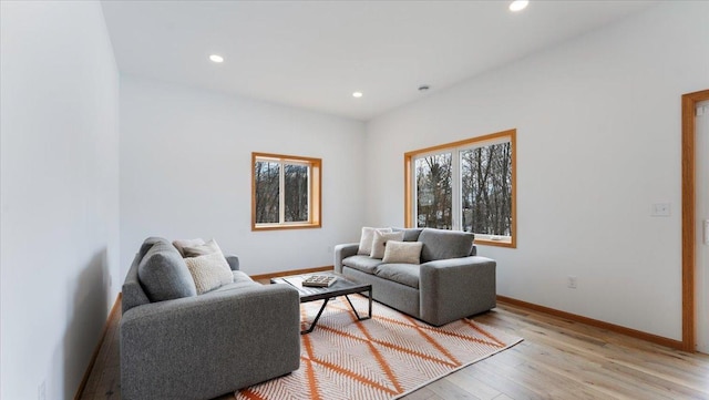 living room with light wood finished floors, baseboards, and recessed lighting