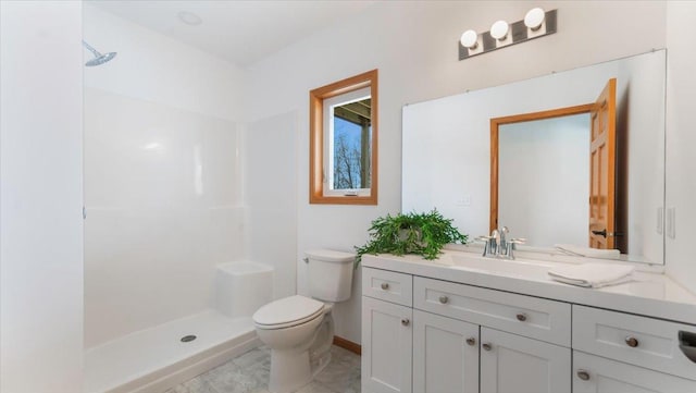 full bathroom with vanity, walk in shower, toilet, and baseboards