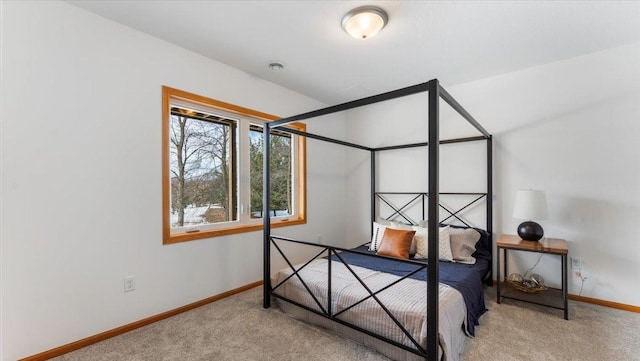 bedroom featuring carpet floors and baseboards