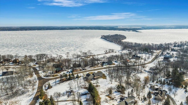 snowy aerial view with a water view