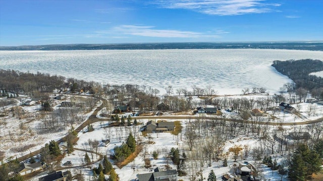 snowy aerial view with a water view