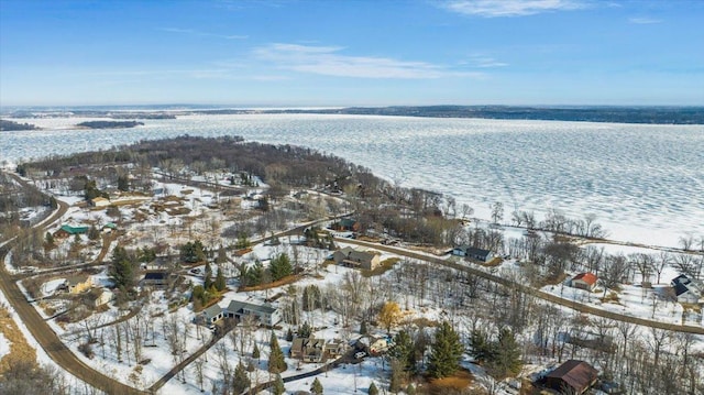 snowy aerial view with a water view