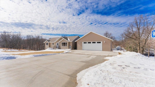 ranch-style home featuring driveway and an attached garage