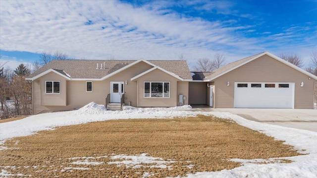 ranch-style house with concrete driveway, a lawn, and an attached garage