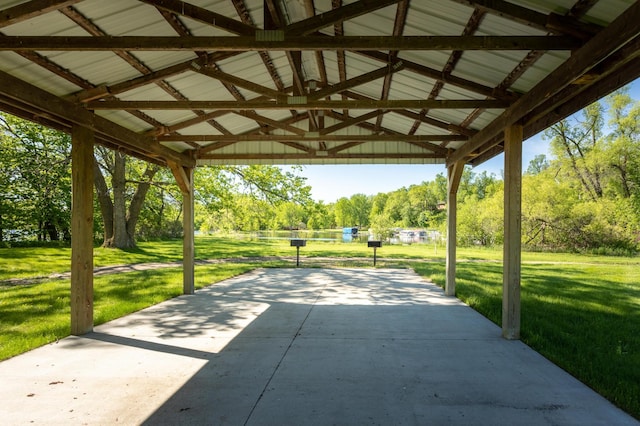 view of community featuring a carport and a yard