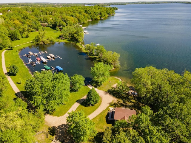 birds eye view of property with a forest view and a water view